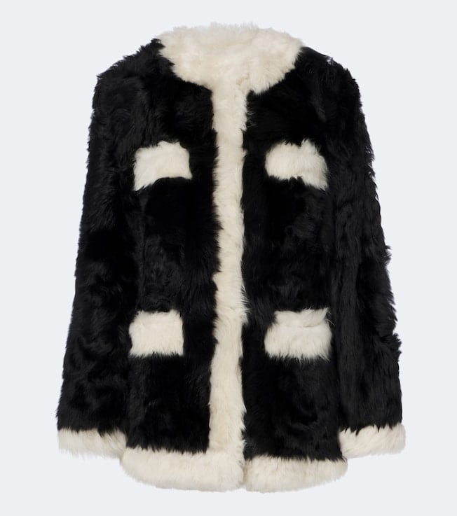 Black and cream fuzzy coat with geometric patchwork pattern and white collar lining
